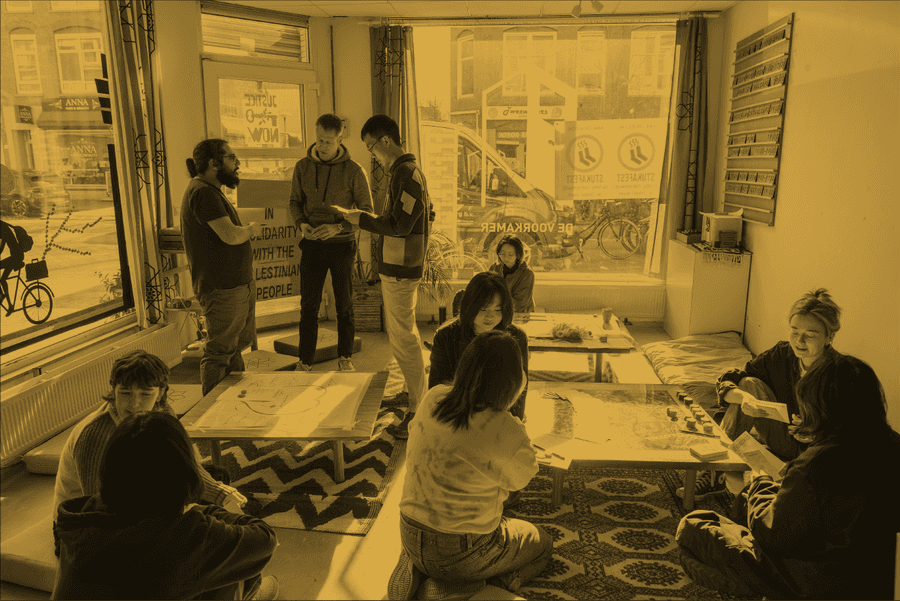 People gathering with floor seating and some standing
